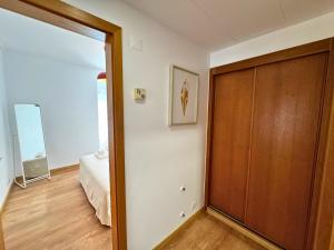 a room with a closet and a bed and a door at Tejo Balcony Expo in Lisbon