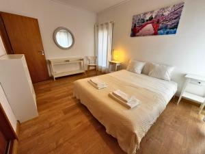 a bedroom with a bed with two towels on it at Tejo Balcony Expo in Lisbon