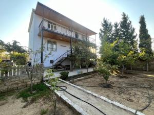 a house with a garden in front of it at Dubendi resort villa in Baku
