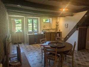 a kitchen and dining room with a table and chairs at Bulle Nature in Publy +16 photos