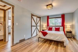 a bedroom with a bed with red curtains and a window at Luxury Spacious House Great For A Family Retreat in Loveland