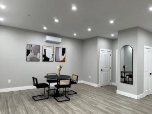 a dining room with a table and chairs and a mirror at Spacious Modern 1 Bedroom RARE Apt w GYM in Albany +8 photos