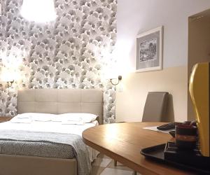 a bedroom with a bed and a wooden table at Sweet Dreams Roma in Rome