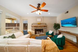 a living room with a ceiling fan and a fireplace at Rancho Bernardo Home - Game Room Outdoor Living in Rancho Bernardo