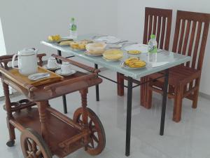 a table with a cart with food on it at Lake Lower Hotel & Yala Safari in Tissamaharama