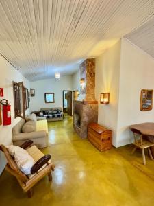 ein Wohnzimmer mit Couch und Kamin in der Unterkunft Pousada Loquinhas in Alto Paraíso de Goiás