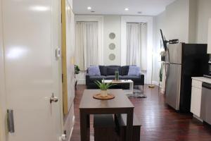 a kitchen and living room with a couch and a table at RARE 1BR Apt with Character GREAT Location! in Albany