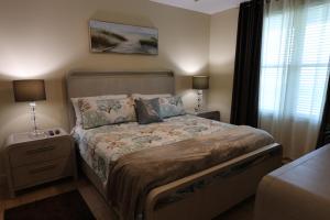 a bedroom with a bed and a table with a lamp at AQUA 1504 Beachfront condo with Free Beach Chairs in Panama City Beach +118 photos