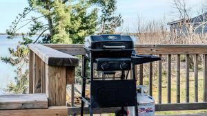 a grill on a stand next to a wooden fence at Georgian Bay Lakeview Cottage - Rockwood #5 in Dillon