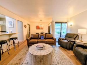 a living room with a couch and a table at Flying Dutchman 1104 by SummitCove Lodging in Keystone
