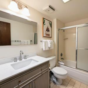 a bathroom with a sink and a toilet and a shower at Flying Dutchman 1104 by SummitCove Lodging in Keystone