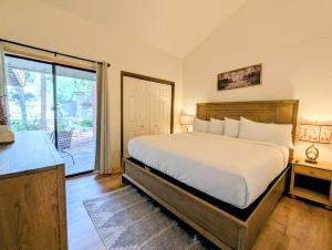 a bedroom with a bed and a sliding glass door at Flying Dutchman 1104 by SummitCove Lodging in Keystone +58 photos