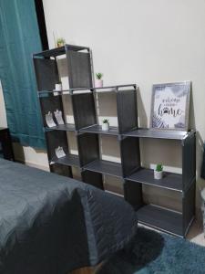 a black book shelf in a room with a bed at Depa Andali travel in Aguascalientes