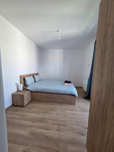 a bedroom with a bed and a wooden floor at Castle View in Rasnov in Râşnov