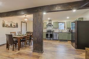 a kitchen with a table and chairs and a refrigerator at Refined 6br Moose & Bear Lodge By Sweetheart Stay in Livingston