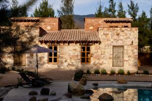 a stone house with a pool in front of it at Sierra Urbana Etla in San Agustín Etla