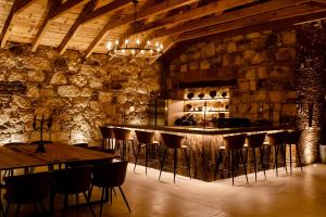 a bar in a room with a stone wall at Sierra Urbana Etla in San Agustín Etla