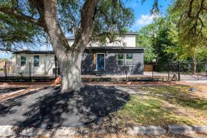 a tree in a yard in front of a house at Gated 3BR Sleeps 7 Med Center NRG Downtown in Houston