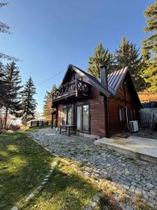 a log cabin with a stone path in front of it at The mountain house Dora in Kochani +51 photos