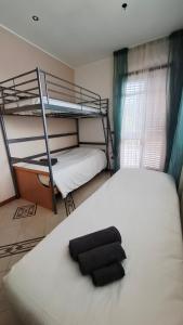 a bedroom with two bunk beds and a black pillow at The Happy Goat Apartment in Germignaga
