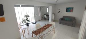 a living room with a table and a couch at Departamento Moderno in Neuquén