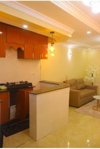 a kitchen and living room with a couch in a room at Ann'sbammyline Serene homes in Ruiru