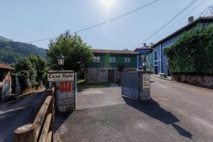 a gate to a house with a sign on a street at Casa Balo in Cangas de Onís