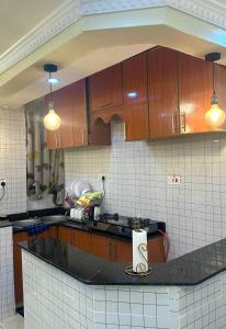 a kitchen with wooden cabinets and a counter top at Ann'sbammyline Serene homes in Ruiru