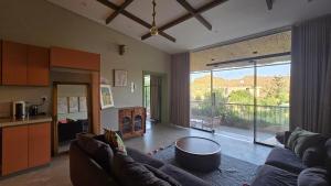 a living room with a couch and a table at Cactus Bloom زهرة الصبار in Taif +38 photos
