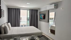 a hotel room with a bed and a window at Blue Sunset Family Experience in João Pessoa