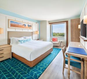 a hotel room with a large bed and a television at Margaritaville Hotel Kansas City in Kansas City +31 photos
