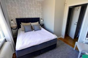 a bedroom with a large bed with blue pillows at KAL791-Vimmerby-Fredensborg-120 in Storebro