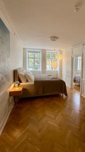 a bedroom with a large bed and two windows at Beautiful apartment i 4 in Copenhagen