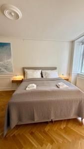 a bedroom with a large bed with two towels on it at Beautiful apartment i 4 in Copenhagen