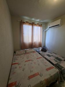a bed in a room with a window at Apartamento para COP 30 in Marituba