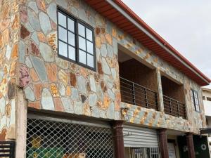 a building with a mosaic facade with a balcony at Jayda Lodge in Kwedonu