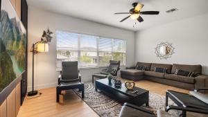 a living room with a couch and a table at 6BR Luxury Home with Private Pool and BBQ in Kissimmee +41 photos