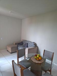 a living room with a table with a bowl of fruit on it at Apartamento para COP 30 in Marituba