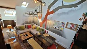 a living room with a tree mural on the wall at Studios with Mezzanine Rua da Moeda in Lisbon