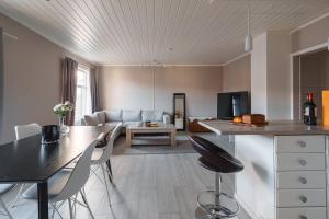 a kitchen and living room with a table and chairs at Arctic Apartment Heart of Tromsø in Tromsø
