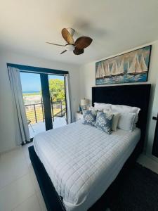 a bedroom with a bed and a ceiling fan at Casa Blue Laguna2 in Las Croabas
