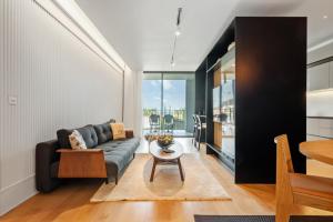 a living room with a couch and a table at Luxury 5-Star Stay at Savoy Insular in Funchal +18 photos