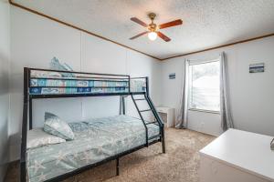 a bedroom with a bunk bed and a ceiling fan at 5 Mi to Homosassa Springs Park Home with Yard! in Homosassa