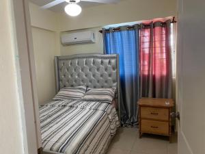 une chambre avec un lit et une fenêtre avec des rideaux dans l'établissement Brisa de mar BOCA CHICA,, à Boca Chica 24 autres photos