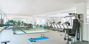 a gym with tread machines and a mirror at Embassy Onebedroom by Unique Abodes in Accra