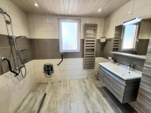 a bathroom with a sink and a shower and a mirror at Les Antilles, maison de bord de mer in Pirou +24 photos