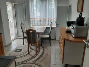 a kitchen with a table and chairs and a microwave at Wohnen auf Zeit HF in Herford