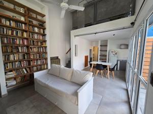 a living room with a couch and bookshelves at Casa Azul in Neuquén