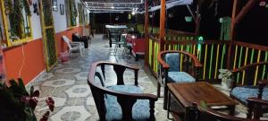 a restaurant with chairs and a table in a room at Finca en el Quindío - Arrullo Cafetero in Quimbaya