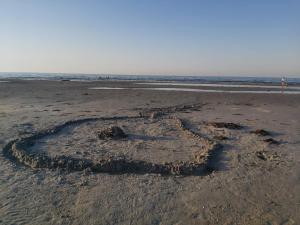 a heart drawn in the sand on the beach at 4 person holiday home in Allingåbro-By Traum in Allingåbro +24 photos